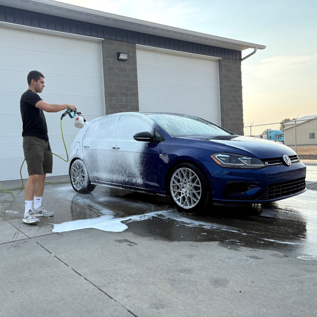 Refined Rides technician foam washing a Golf R