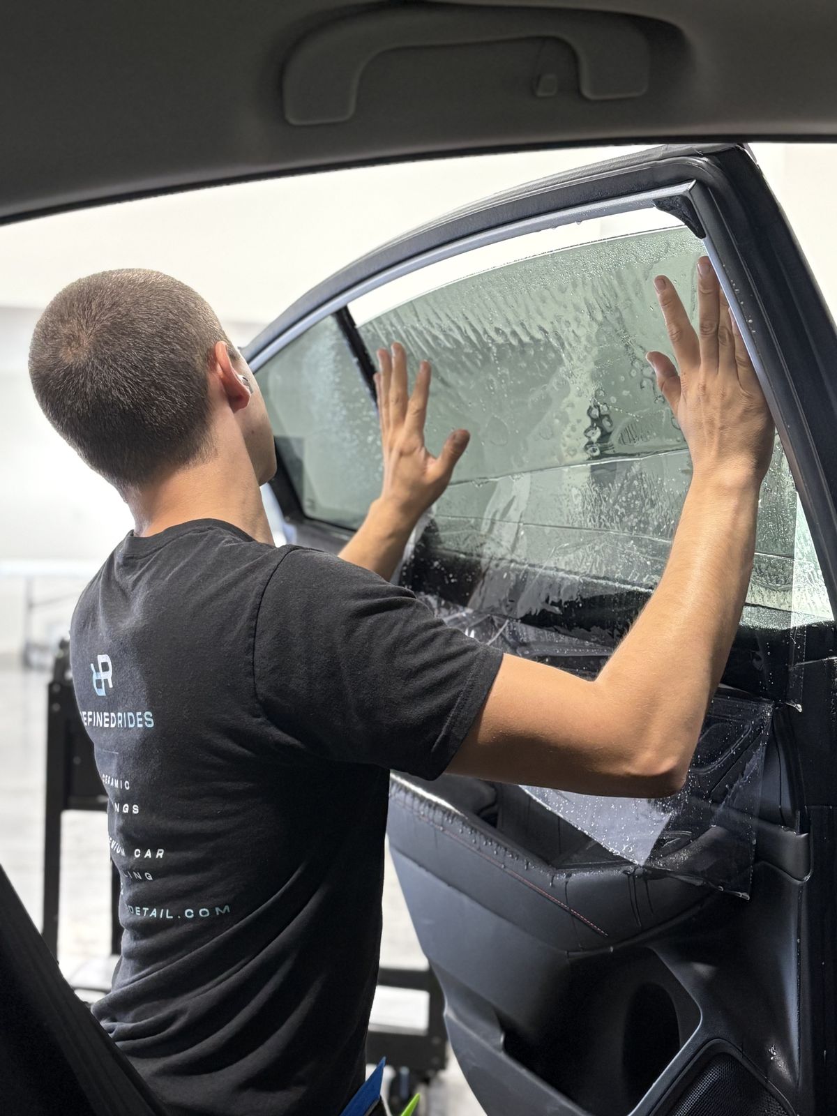Refined Rides technician installing window tint